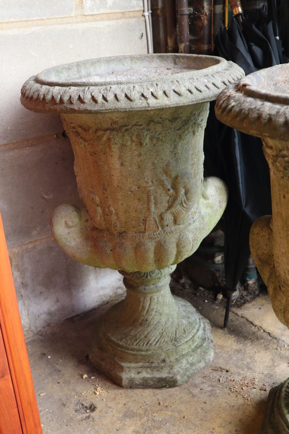 A pair of reconstituted stone garden urns, height 60cm